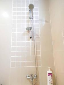 a shower in a bathroom with a shower head at [HERITAGE 9] HOMESTAY Studio 4Pax, FREE WIFI in Seri Kembangan