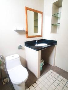 a bathroom with a toilet and a sink and a mirror at [HERITAGE 9] HOMESTAY Studio 4Pax, FREE WIFI in Seri Kembangan