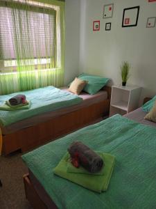 a bedroom with two beds with a stuffed animal on a tray at Holiday home Ivano in Korenica