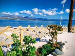 een hek op het strand met uitzicht op het water bij Bahia- apartment by the sea,close to cedar forest! in Elafonisos