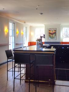 a kitchen with a bar with chairs and a sink at Kent Island Resort in Stevensville