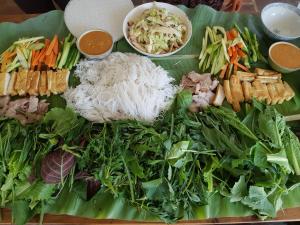 a plate of food with vegetables and other foods at Midori Coffee Farm in Da Lat