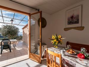 a dining room with a table and a glass door at Holiday Home Campestra by Interhome in Coti-Chiavari