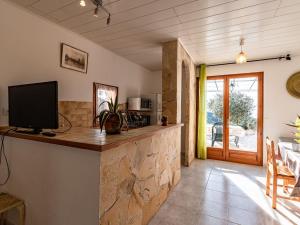 a kitchen with a counter with a tv on it at Holiday Home Campestra by Interhome in Coti-Chiavari
