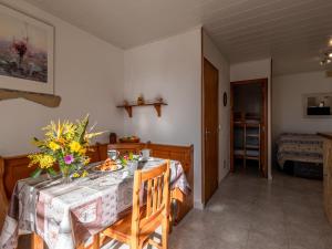 a dining room with a table with flowers on it at Holiday Home Campestra by Interhome in Coti-Chiavari