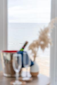 a table with two bottles of champagne and two glasses at The Pearl Suite by Margate Suites in Margate