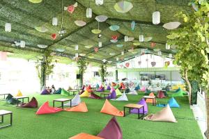 a group of colorful chairs on the floor of a building at MCM HOTEL WISATA BOJONEGORO in Bojonegoro