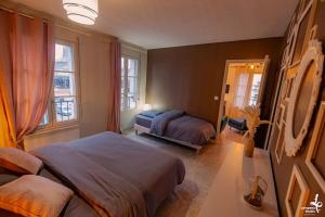 a bedroom with two beds and a mirror at Appartement Romance Florale Troyes in Troyes