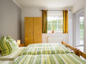 a bedroom with a bed and a window at Apartment Kiefernweg by Interhome in Ramersbach