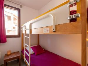 a bunk bed in a small room with a purple bed at Apartment Les Coteaux de la Nartelle-17 by Interhome in Sainte-Maxime