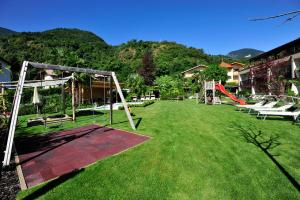 a large yard with a swing set and a playground at Modern Living by Nalserhof in Nalles