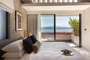 a bedroom with a large bed with a view of the ocean at Kerem Luxury Beachfront Villas in Nathon Bay