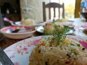 a plate of rice on a table with dishes of food at Live in Nature in Darjeeling