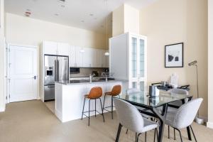 a kitchen with a glass table and chairs at Penn Quarter 2BR w Gym Pool nr National Mall WDC-167 in Washington