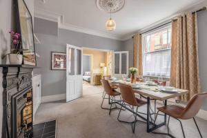 a dining room with a table and chairs and a fireplace at Stylish Home Central Windsor-Walk 2 All The Sights in Windsor +15 photos