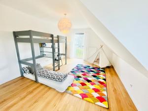 a room with a bunk bed and a rug at Wasserspaß pur - Luxus Ferienhaus bei Berlin, direkt am Wasser, inkl SUPs und Schlauchboot! in Oranienburg