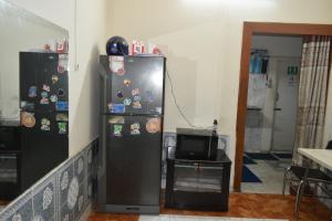 uma cozinha com 2 frigoríficos e uma televisão num quarto em Homestay 2 em Daca