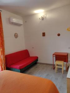 オルヴィエートにあるLa Rosa di Orvietoの赤いソファとテーブルのあるリビングルーム