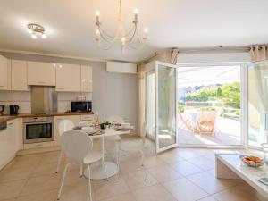 a kitchen and dining room with a table and chairs at Apartment Les Rivages de L'Esterel-2 by Interhome in Boulouris-sur-Mer