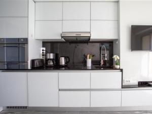 a kitchen with white cabinets and a counter top at Apartment L'Angelina-1 by Interhome in Cros-de-Cagnes +21 photos