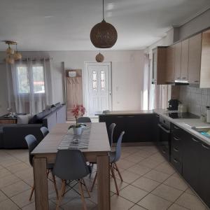 a kitchen and living room with a table and chairs at Villa Ioulia Malakonda, Eretria ,Greece in Eretria