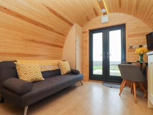 a living room with a couch and a large window at Sun Rise in Penzance