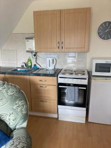 a kitchen with a stove and a microwave at Happy Holiday apartments in Mablethorpe