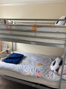 a bunk bed with two stuffed animals sitting on it at Happy Holiday apartments in Mablethorpe