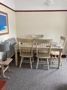 a dining room with a table and chairs at Happy Holiday apartments in Mablethorpe
