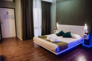 a bedroom with a large bed with green pillows at TH LUXURY SUITE in Giardini Naxos