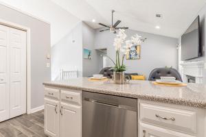 a kitchen with white cabinets and a counter top at Unwind in a Modern Riverdale Home in Riverdale