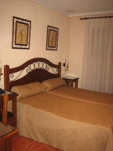 Säng eller sängar i ett rum på Hotel Doña Isabel