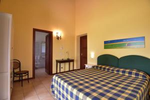 a hotel room with a bed and a bathroom at L'Orto di Lucania in Montescaglioso