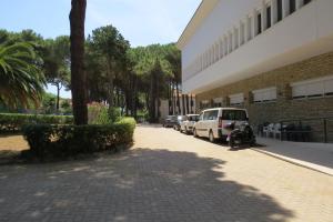 a parking lot with cars parked next to a building at San Giuseppe Casa per Ferie in Quercianella