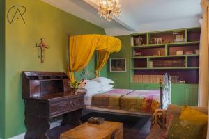 a bedroom with a bed and a cross on the wall at Luxury Rural Family Getaway with Tennis Court in Buckinghamshire
