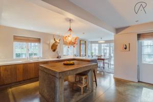 a large kitchen with a island in the middle at Luxury Rural Family Getaway with Tennis Court in Buckinghamshire