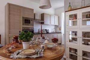 a kitchen with a wooden table with dishes on it at Casa in campagna la Roverella in Francavilla dʼEte