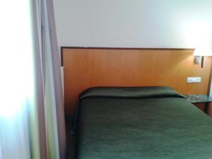 Postel nebo postele na pokoji v ubytování Hostal Meson Pepa