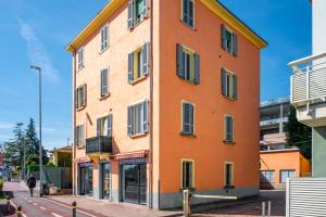 an orange building on the side of a street at Parma Centro Torri Huge Apartment x6 in Parma
