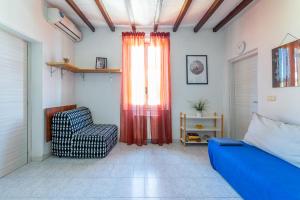 a living room with a blue couch and a chair at Parma Centro Torri Huge Apartment x6 in Parma