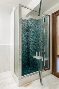 a bathroom with a shower with a glass door at Casa Ambrosini Apartments by Wonderful Italy in Bologna +69 photos