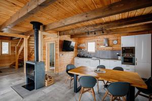 a kitchen and dining room with a table and a stove at Chata pod Stupkou in Mýto pod Ďumbierom