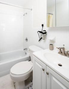 a white bathroom with a toilet and a sink at Cozy and new fully furnished 1BD/1BR in Park Slope in Brooklyn