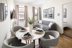 a living room with a table and chairs at Cozy and new fully furnished 1BD/1BR in Park Slope in Brooklyn