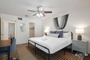 a bedroom with a bed and a ceiling fan at Walk to Everything - Fun Hyde Park Space King Bed in Austin