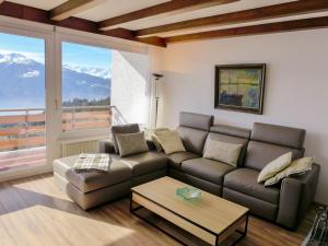 a living room with a couch and a table at Apartment La Clairière des Barzettes A-B-7 by Interhome in Vermala