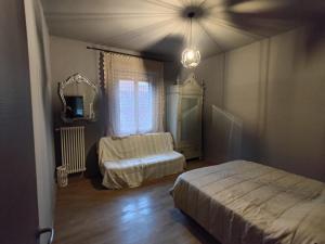 a bedroom with two beds and a mirror at HomeStory 2 via Idice 72 Pizzano BO in Casa Canovetta