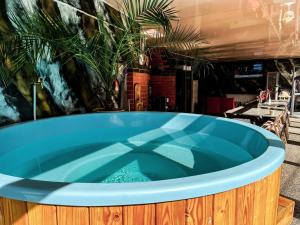 a jacuzzi tub in a restaurant with a table at TRANSILVANIA BLISS COTTAGE in Someşu Rece