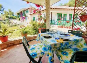 a table with a blue and yellow table cloth on a patio at La Lomita in Santa Marinella