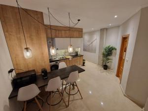 a kitchen with a table and chairs in a room at Carthago Suites (Centro - Casco histórico) in Cartagena